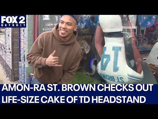 Lions' Amon-Ra St. Brown checks out Rochester bakery's life-size cake of his TD celebration