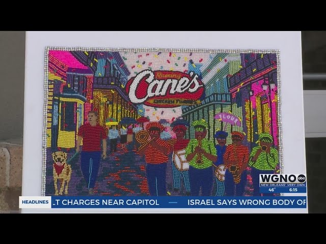 Queen Tahj signs new Mardi Gras posters at Raising Cane's