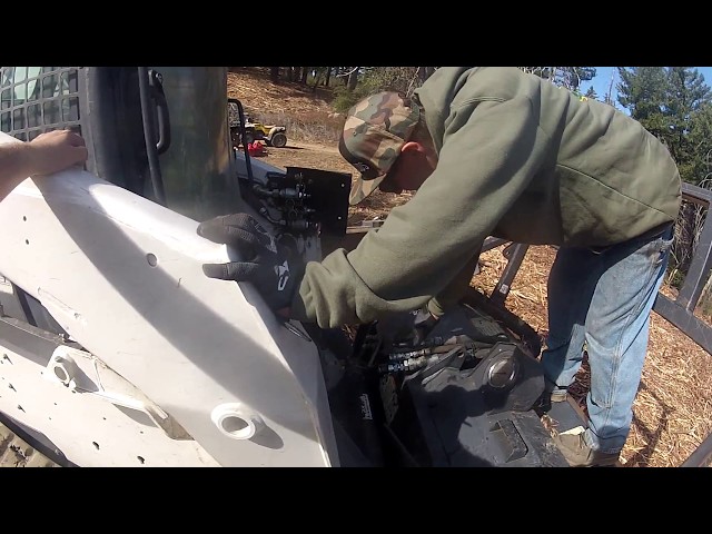 Switching Bobcat Skid steer attachment manually from Masticator to Blade