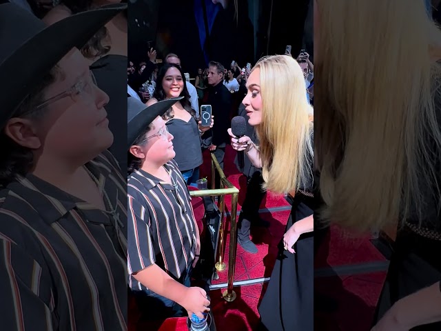 Adele sings to a young fan in the audience