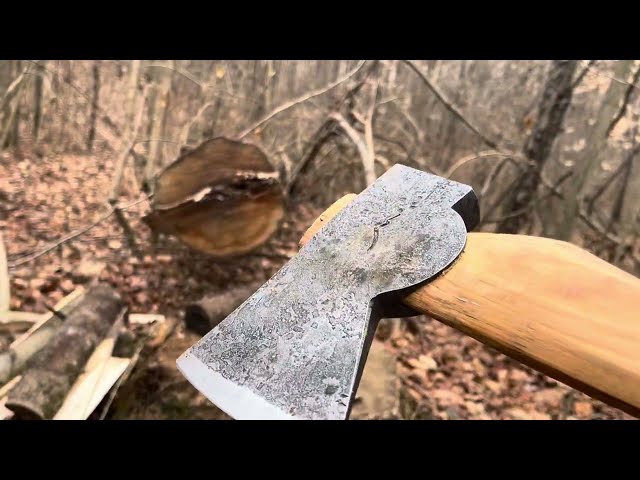 Hoffman Blacksmithing Wasatch Axe splitting some logs.