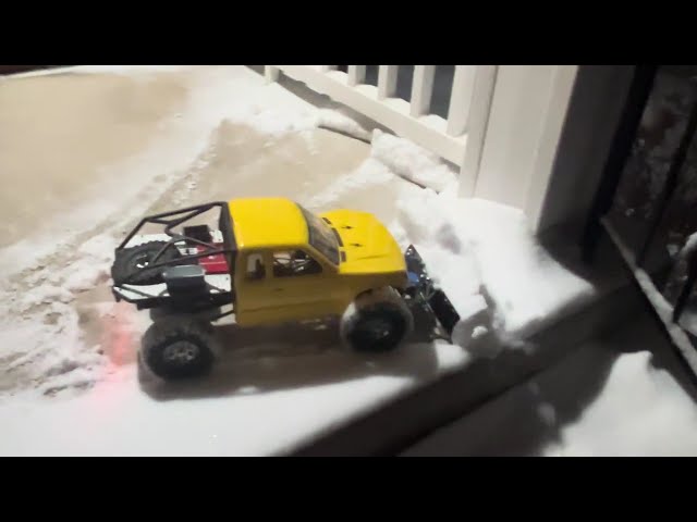 Axial SCX10 RC Snowplow clearing the porch.