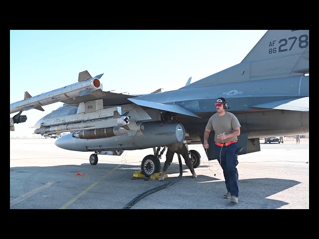 U.S. Airmen conduct hot pit refueling of two F-16 Fighting Falcons Sept. 30, 2021.