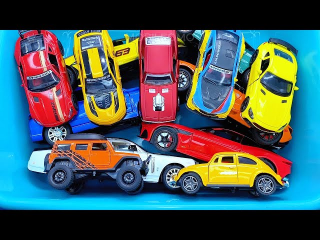 Box full of various miniature cars Jaguar, Peugeot, Renault, Hyundai, Mazda, Volvo, Honda, Opel