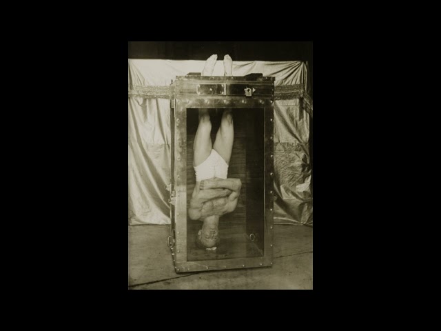 1914: Harry Houdini on his Water Torture Cell