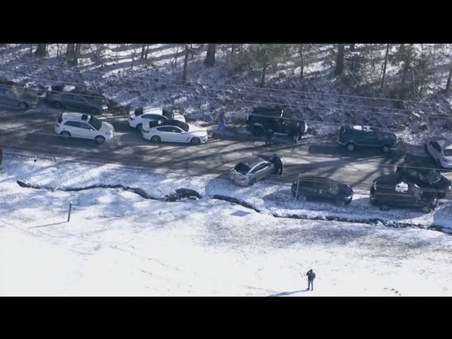 Drivers try to reunite with towed cars after being forced to abandon due to icy road conditions