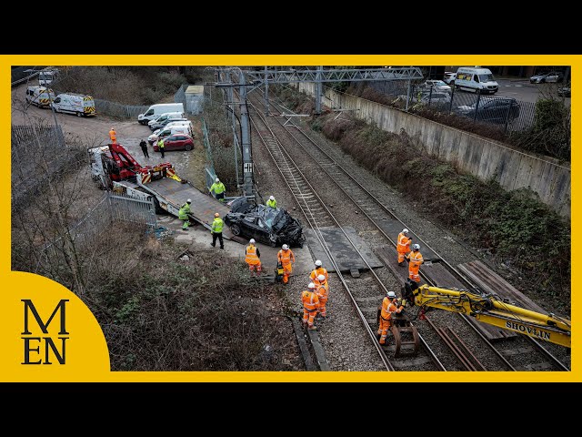 Recovery underway after car crashes onto train tracks in Salford