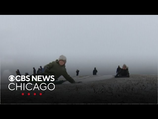 Kids go sledding, grown-ups scrape off cars as snow socks Chicago