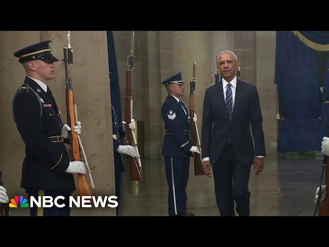 Obama and Clintons draw boos from Trump supporters watching from parade arena