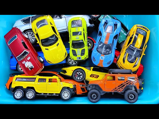 Box full of various miniature cars Jaguar, Peugeot, Renault, Hyundai, Mazda, Volvo, Honda, Opel