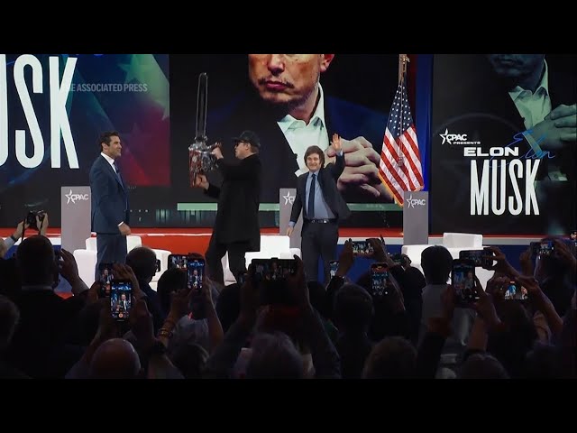 Elon Musk waves chainsaw on stage at CPAC