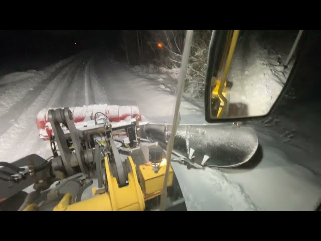 Snow plowing road and cutting snow banks [side wing cam]