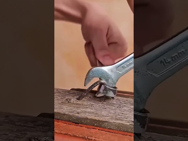 Bending and Embedding a Nail into Wood Using a Wrench and Hammer