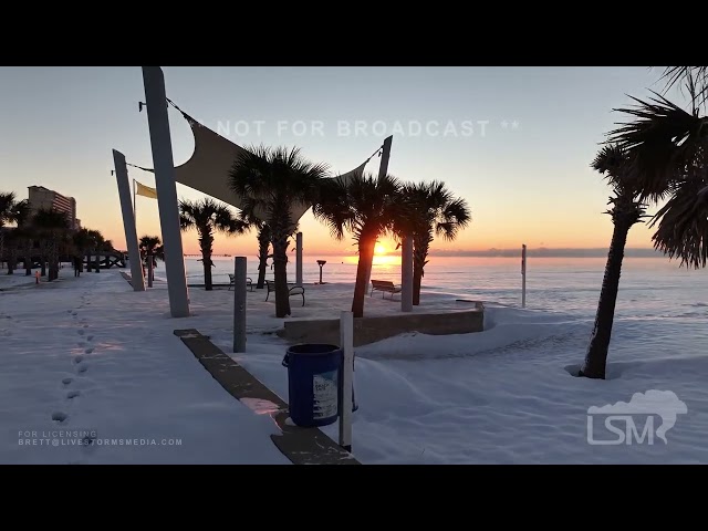 01-22-2025 GULF SHORES, AL - A rare sunrise over snow capped beach in Gulf Shores.