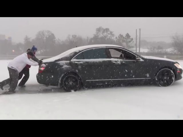 Houston driver stuck in snow spins out again on freeway