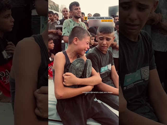 Palestinian boy holds shoes of killed father | #AJshorts