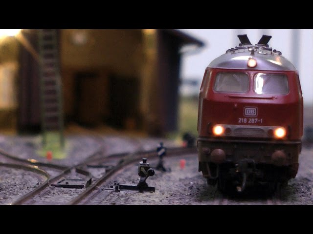 Model railway with station and very realistic landscape in HO scale