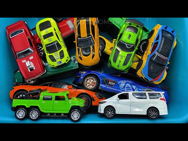 Box full of various miniature cars Jaguar, Peugeot, Renault, Hyundai, Mazda, Volvo, Honda, Opel