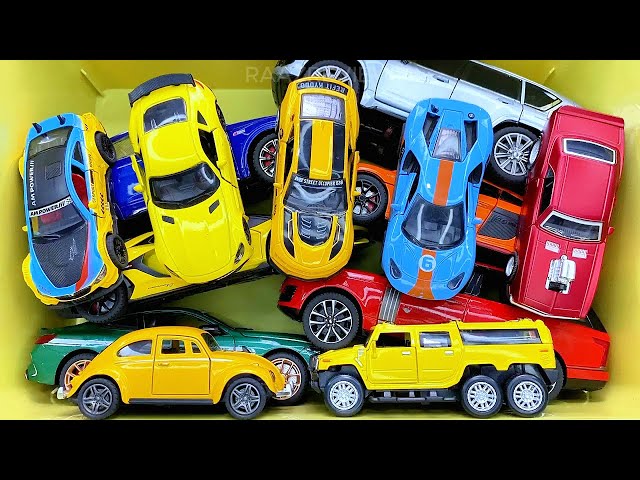 Box full of various miniature cars Peugeot, Volvo, Renault, Hyundai, Pagani, Cadillac One, DHL 13