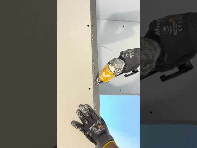 Stapling on drywall corner bead.