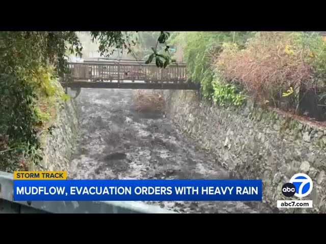 Muddy runoff rushes through canals in Eaton Fire zone