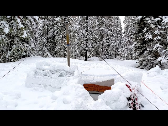 Winter Camping In Snow Shelter During A Storm