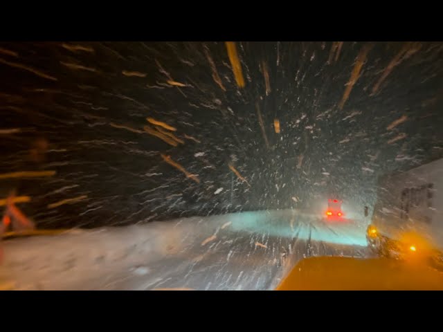 Trucking in a blizzard-Alaska Mountain Pass heavy snow.