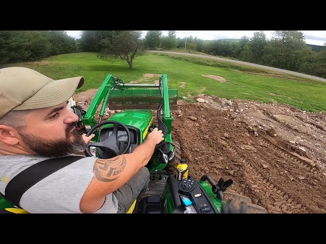 John Deere 4044M pushing soupy clay