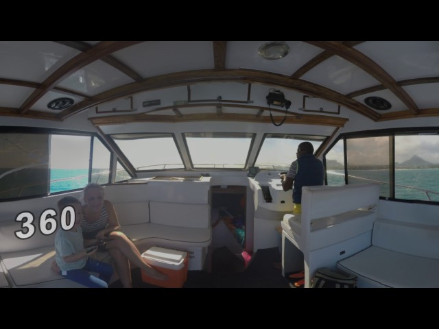 360 VR Family traveling by yacht. Inside view with captain driving vessel