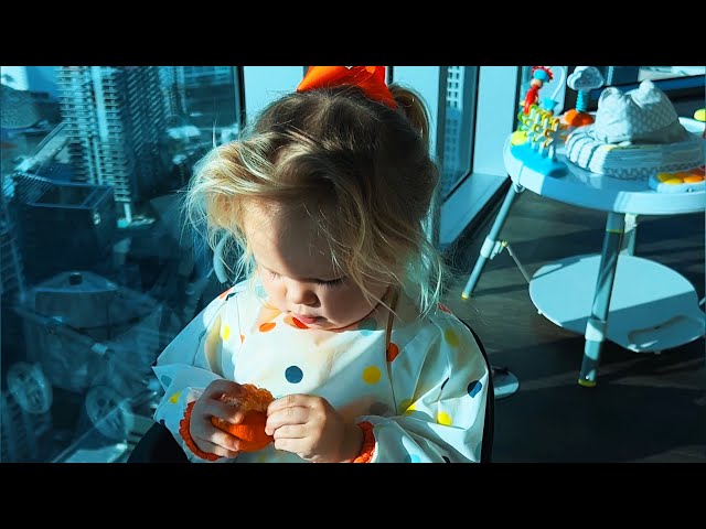 Little toddler Naomi eats tangerine