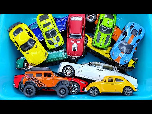 Box full of various miniature cars Jaguar, Peugeot, Renault, Hyundai, Mazda, Volvo, Honda, Opel