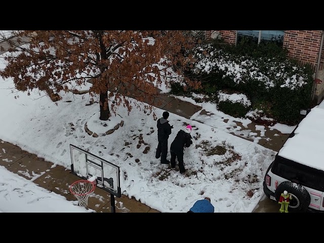 Kids Building a Snow Man in North Texas Snow Storm via Drone