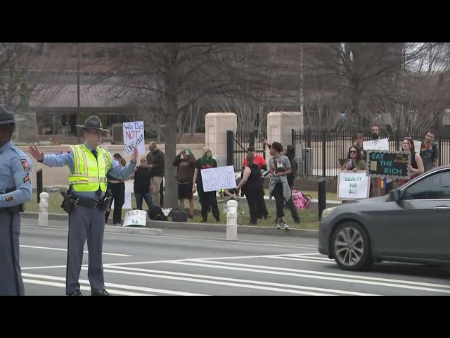 Protesters rally in Atlanta against President Donald Trump's policies