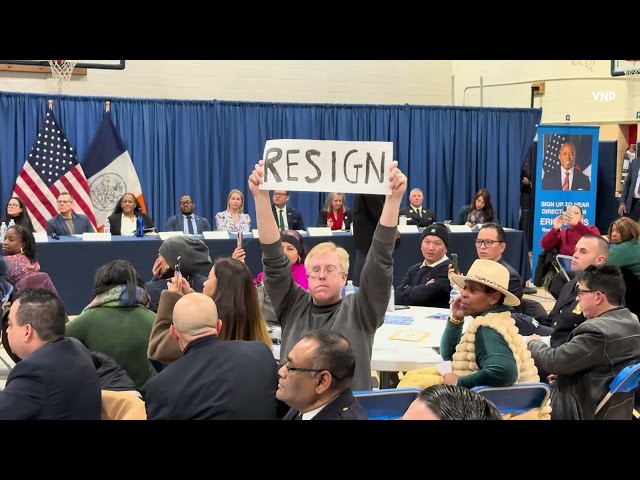 Protester Confronts Mayor Eric Adams: 'Resign!' Sign at Community Meeting at IS.61 / NYC 1.22.25