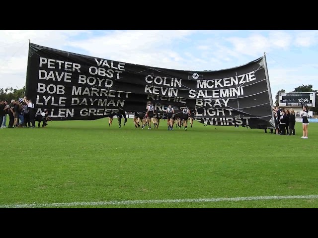 Port Adelaide players running through the 2018 SANFL Rd 9 Port Adelaide v North Adelaide banner