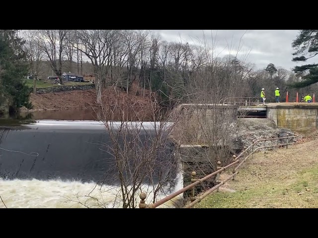 Crew works atop the Fitchville Dam in Bozrah after heavy rains caused the dam to partially fail