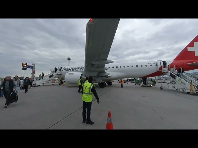 VR: In front of small swiss airplane (helvetic airline)