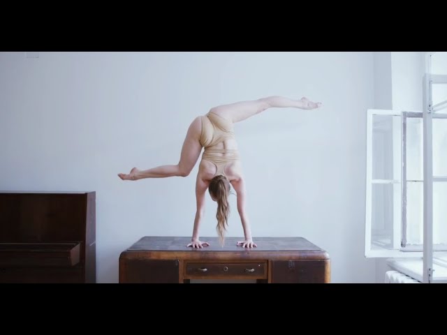 Yoga at handstand on a wooden desk