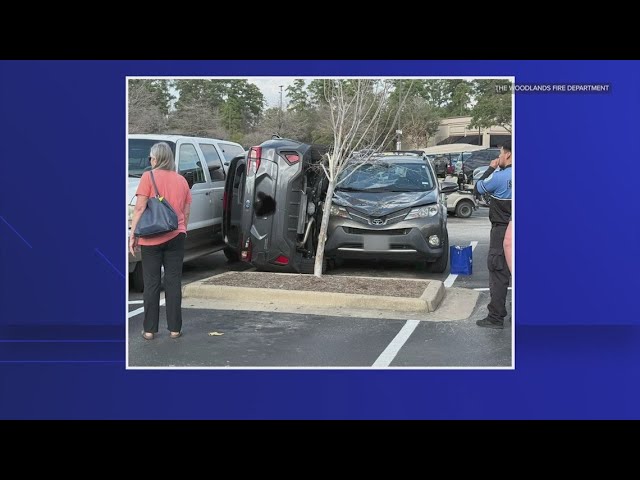 Car gets wedged in H-E-B parking lot in The Woodlands