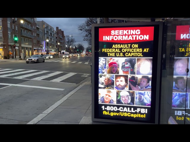 One Minute in D.C.— FBI Wanted Posters for Capitol Rioters in a Washington DC Bus Stop