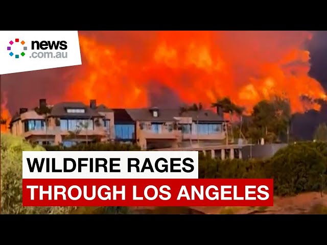 Wildfire tears through affluent Los Angeles suburbs