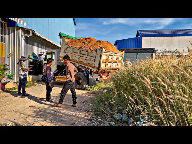 Start a new project!!  Dump Truck Unloading soil into canal  with Mini Bulldozer