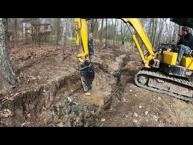 Hammering a drainage trench