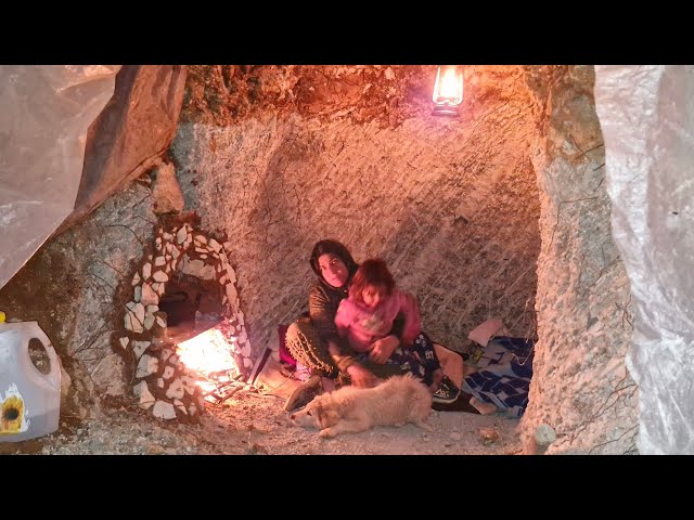 A nomadic woman builds a beautiful fireplace in a cave with minimal resources