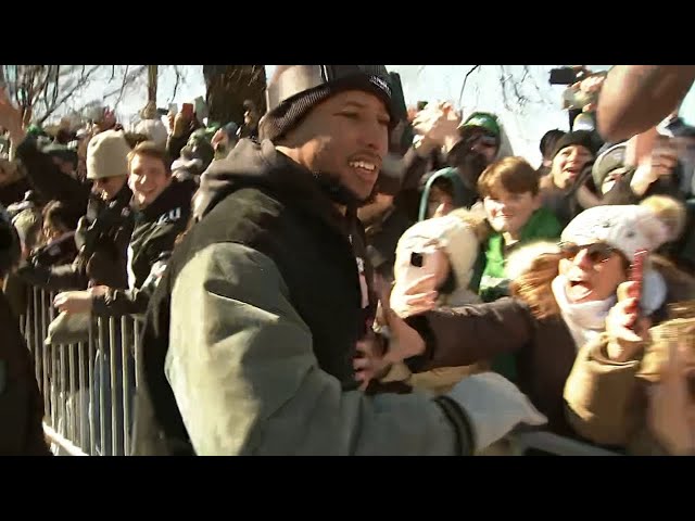 Saquon Barkley hops off the bus and greets fans along parade route