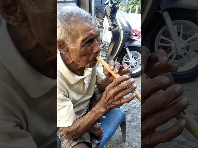 Balinese Oldman Play the Suling, Traditional Bamboo Flute Musical Instrument