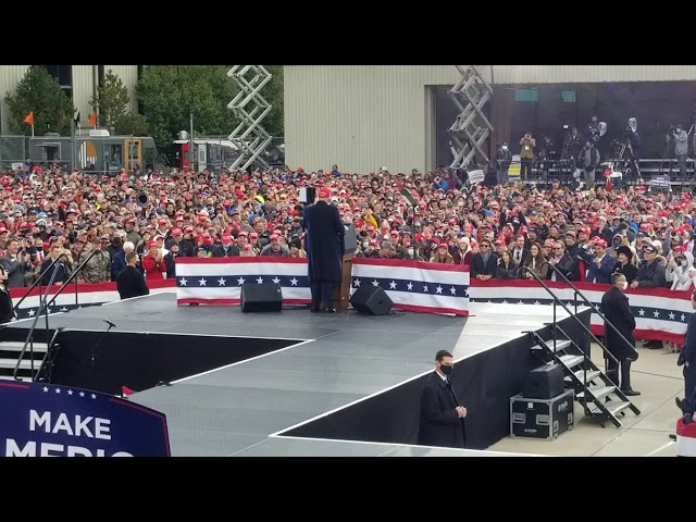 Trump Rally Muskegon Michigan 2020 - Trump puts on MAGA hat.