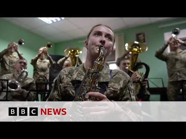 Ukrainian military band use weapons to play Christmas carols | BBC News