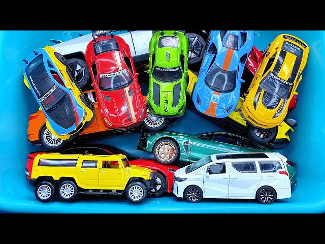 Box full of various miniature cars Jaguar, Peugeot, Renault, Hyundai, Mazda, Volvo, Honda, Opel