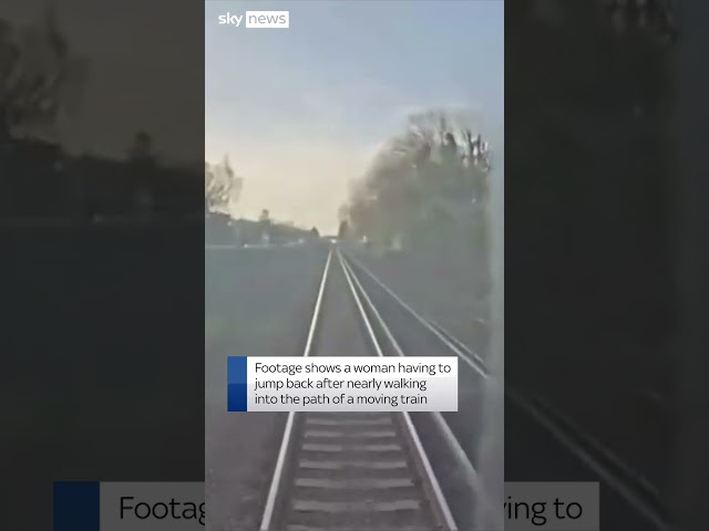 Moment woman is nearly hit by train